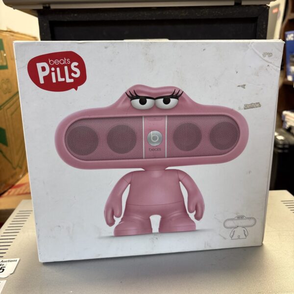 Pink Beats Pill speaker holder, cartoon character design.