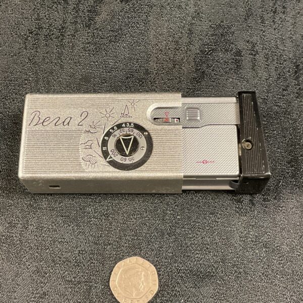 Vintage Bera 2 camera with circular dial on front.