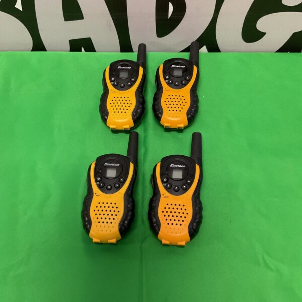 Set of four vintage Binatone walkie talkies for short-range communication.