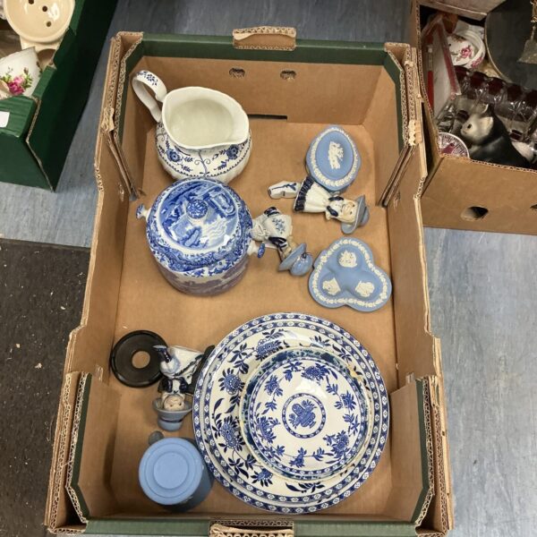 Vintage blue and white china collection with Wedgwood pieces displayed.