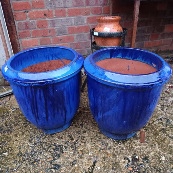 Pair of large blue glazed ceramic plant pots for garden use.