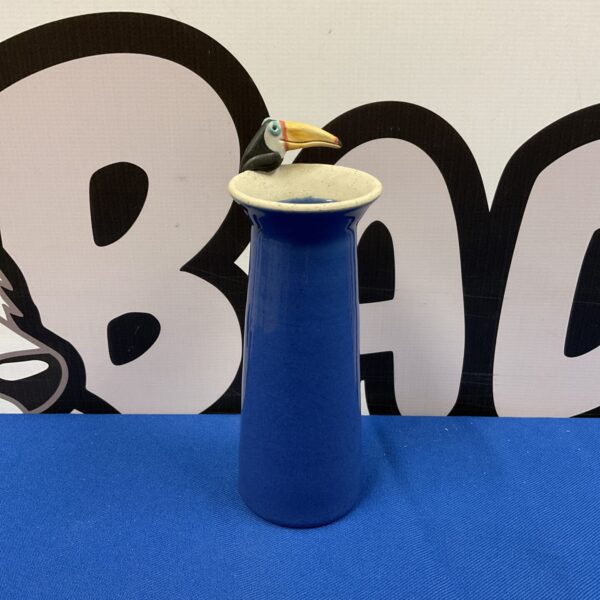 Vibrant blue studio pottery vase with a sculpted toucan.