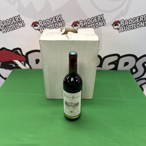 Six bottles of 2004 Bordeaux Superieur wine in a cardboard box.