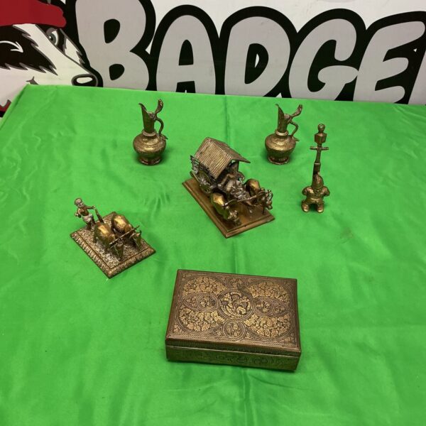Vintage brass ornaments collection with cigarette box and figurines.