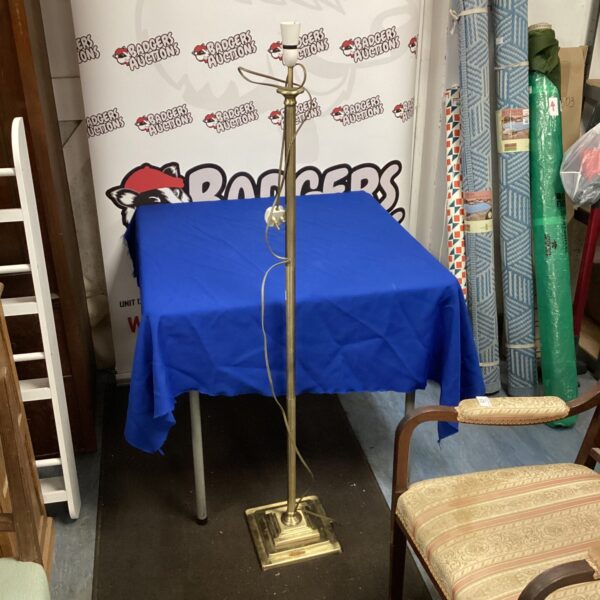 Vintage brass standard lamp with adjustable height and weighted base.