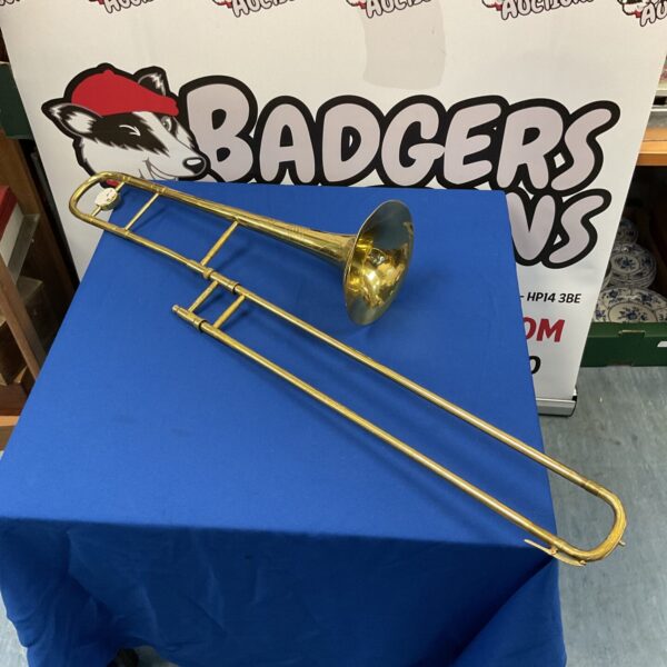 Vintage brass trombone musical instrument with sliding mechanism.