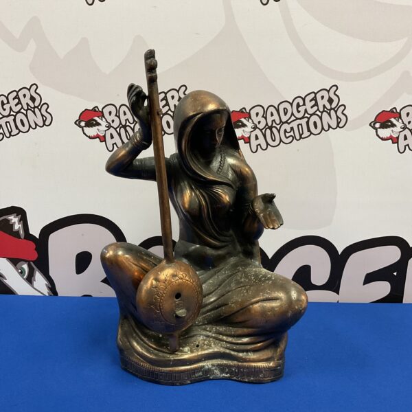 Detailed bronze sitar player sculpture, vintage Indian art.