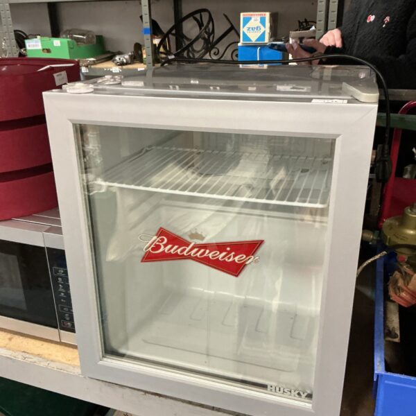 White Budweiser mini fridge with interior shelving.