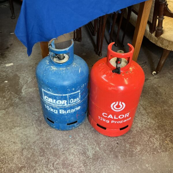 Empty Calor gas bottles, one blue butane and one red propane.