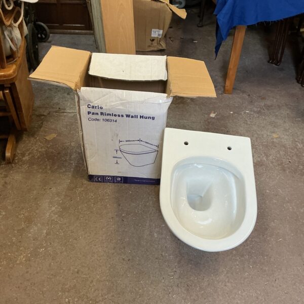 Carlo rimless wall hung toilet bowl in cardboard packaging.
