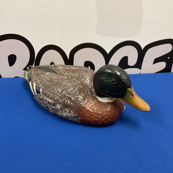 Front view of a detailed hand-carved wooden duck sculpture.