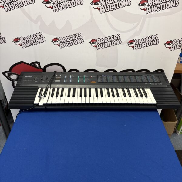Vintage Casio CT-420 electric keyboard with keys and controls.