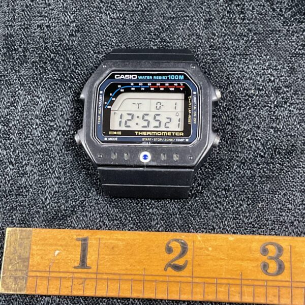 Vintage Casio digital thermometer watch displaying time and temperature.