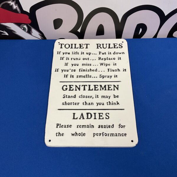 Vintage cast iron toilet rules plaque for bathroom decor.