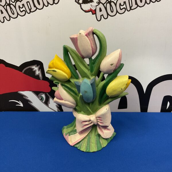 Vintage cast iron tulip doorstop with painted yellow and red petals.
