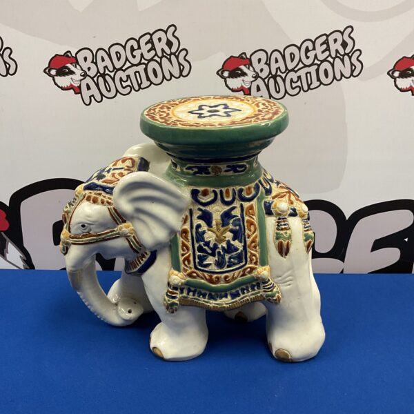 Vintage ceramic elephant plant stand with blue and gold details.