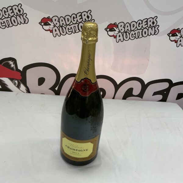Green glass Champagne bottle with foil top.