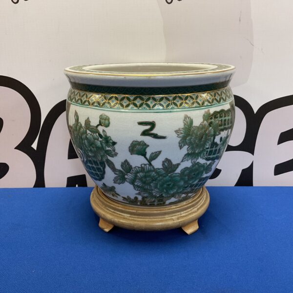 Antique Chinese goldfish bowl with green and gold pattern.