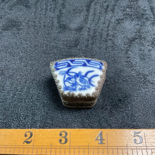 Vintage Chinese porcelain trinket box with blue and white floral design.
