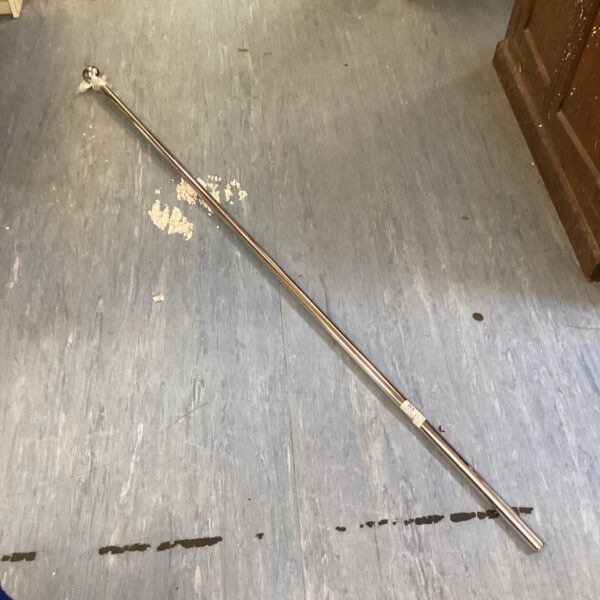 Vintage chrome curtain rail for window treatments.