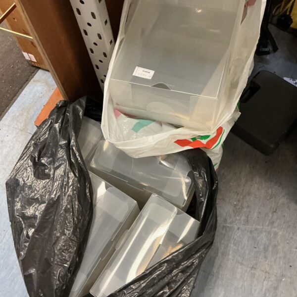 Two bags filled with clear plastic shoe storage boxes for organisation.