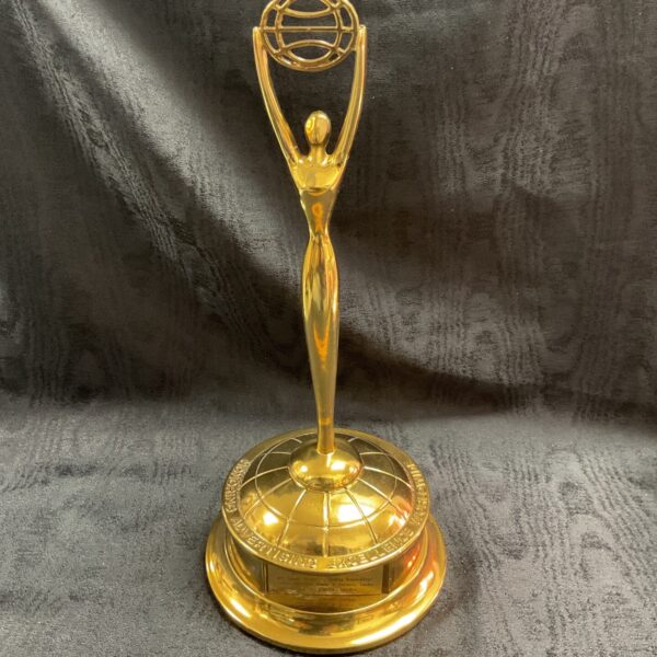 Front view of a golden Clio Award trophy for advertising excellence.