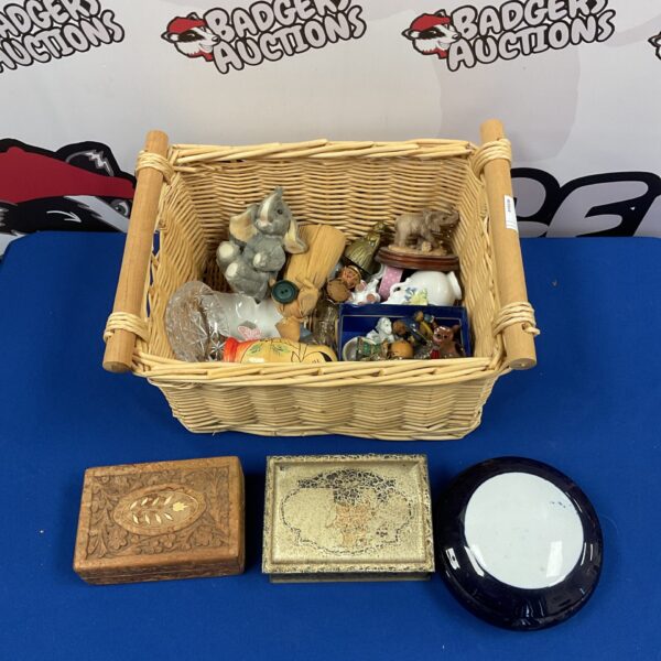 Vintage collectibles basket with animal ornaments and trinket pots.