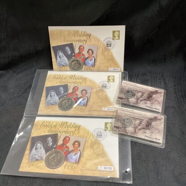 Commemorative coin collection featuring King’s Shilling and Golden Jubilee coins.