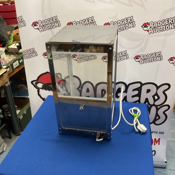 Front view of a vintage commercial popcorn warmer.