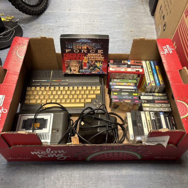 Vintage Commodore 64 Plus console with games and datasette.