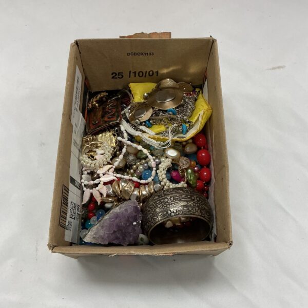 Assortment of vintage costume jewellery including necklaces and brooches.