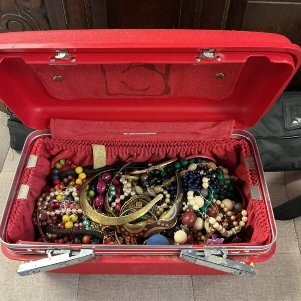 Assortment of vintage costume jewellery in a box.