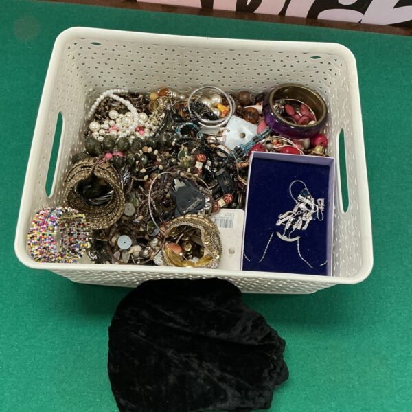 Assortment of vintage costume jewellery including necklaces and brooches.