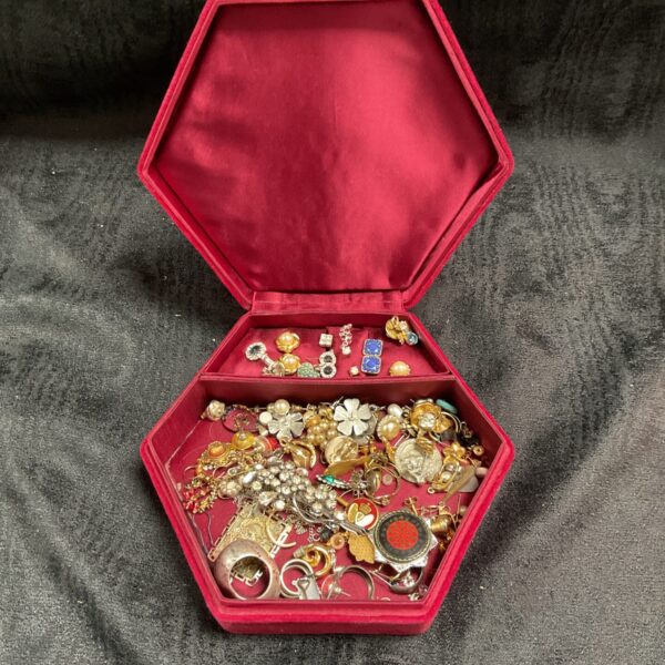 Vintage costume jewellery lot displayed in a velvet box.