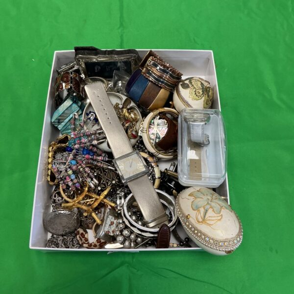 Mixed lot of vintage costume jewellery and watches on display.