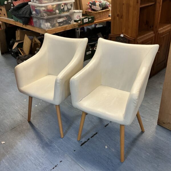 Pair of cream leather McCoy chairs with wooden legs.
