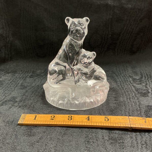 Clear crystal lion sculpture with cub, detailed carving.