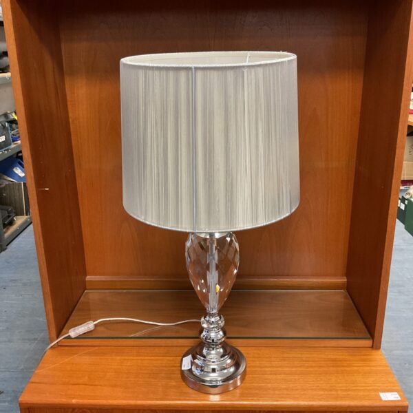 Modern crystal table lamp with chrome base and faceted column.