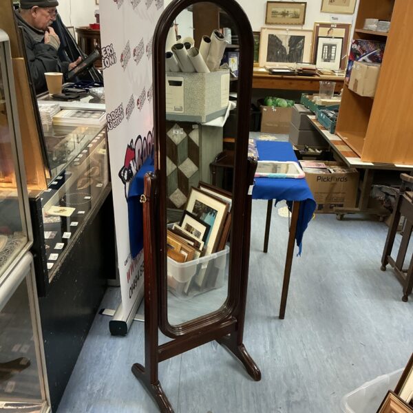 Ornate darkwood dressing mirror with arched top and curved legs.