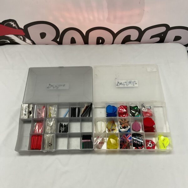 Assorted dart stems and flights in a plastic storage box.