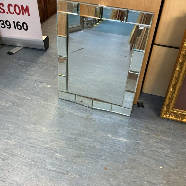 Vintage decorative wall mirror with bevelled edge for home decor.