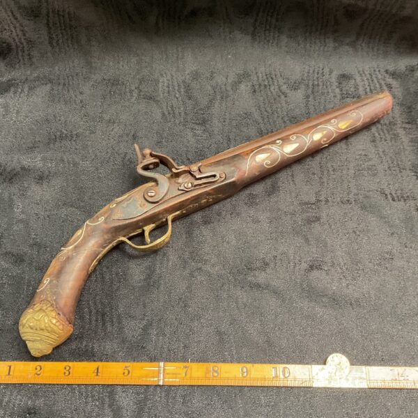 Decorative flintlock pistol for wall display, antique style replica.