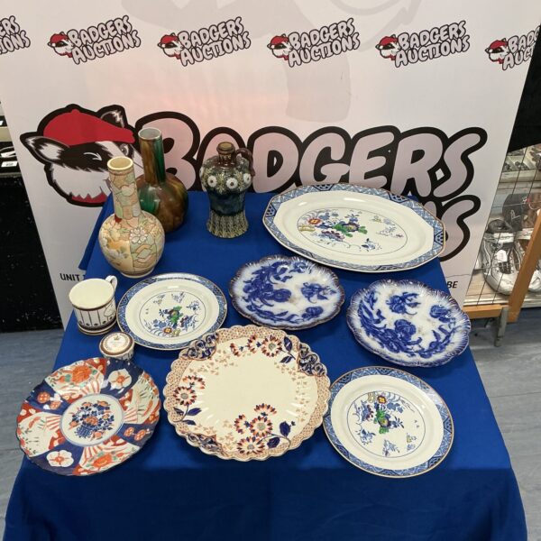 Vintage decorative plates and vases with floral designs.