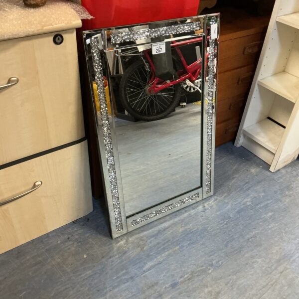 Ornate decorative wall mirror with shimmering crystal border.