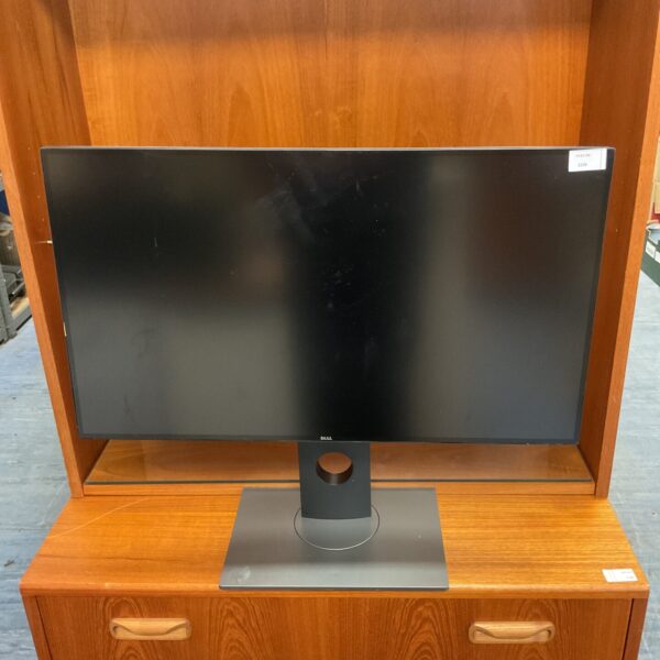 Black Dell 24 inch monitor on a wooden surface.