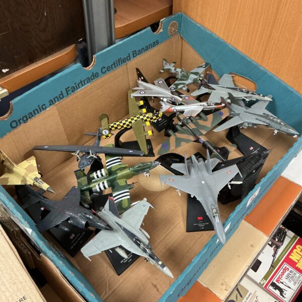 Collection of diecast model aeroplanes with display stands.