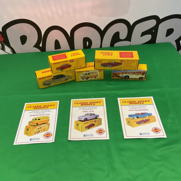 Vintage Dinky Toys diecast cars with certificates of authenticity.