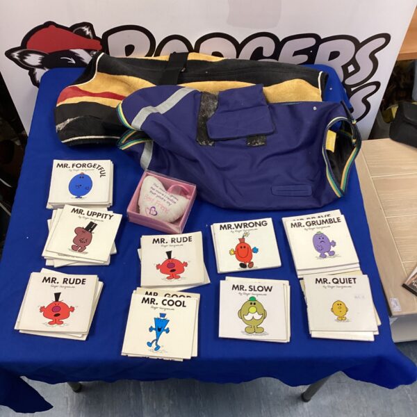 Lot of dog coats and Mr. Men books for sale.