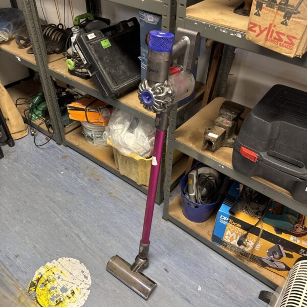 Dyson V6 Absolute cordless vacuum on a shelf, spares or repair.