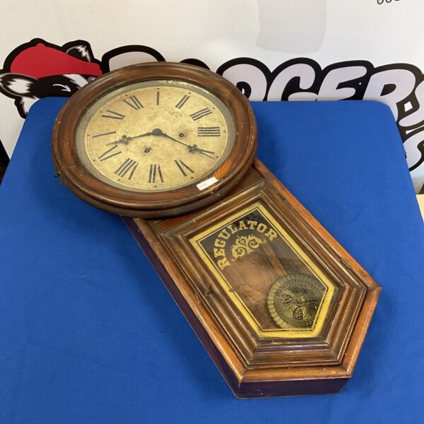 Antique E Ingraham regulator wall clock with porcelain dial.